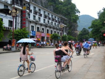 Bikers riding through the town of Yangshuo, China